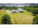 Areal view of backyard, detached garage, sprawling lawn, and mature trees enhance this beautiful home's appeal at 594 Patterson Farm Rd, Mooresville, NC 28115