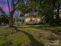 Charming two-story home with a welcoming front porch, illuminated at dusk at 616 W Marion St, Shelby, NC 28150