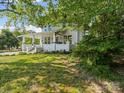 Charming two-story home with a covered front porch surrounded by green lawn at 616 W Marion St, Shelby, NC 28150