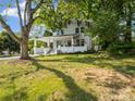 Charming two-story home with a covered front porch and a spacious lawn at 616 W Marion St, Shelby, NC 28150