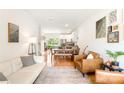 Inviting open-concept living room featuring hardwood floors, comfortable seating, and abundant natural light at 6507 Revolutionary Trl, Charlotte, NC 28217