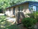 A brick home featuring a small patio area with green shrubs and side entry at 761 Henry Rhodes Rd, Lincolnton, NC 28092