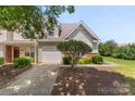 Attractive townhome with a well-maintained lawn, a one-car garage, and a neatly landscaped yard at 825 Rock Lake Gln, Fort Mill, SC 29715