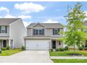 Charming two-story home with a two car garage, long driveway, and manicured lawn at 9136 Creedmore Hills Dr, Charlotte, NC 28214