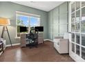 Stylish office space with hardwood flooring, wainscoting, and a large window at 1008 Whipcord Dr, Waxhaw, NC 28173