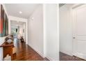 Inviting hallway with hardwood floors, flowing seamlessly into adjacent living spaces and leading to a closed door at 11225 Black Brant Ln, Charlotte, NC 28278