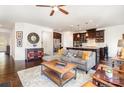 Open-concept living room features hardwood floors and stylish furnishings, flowing seamlessly into the adjacent kitchen at 11225 Black Brant Ln, Charlotte, NC 28278