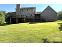 Expansive backyard with a large brick home featuring a chimney and a wooden deck at 1335 33Rd Avenue Ne Dr, Hickory, NC 28601