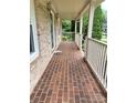 Inviting brick front porch with classic white railings and brick flooring at 1335 33Rd Avenue Ne Dr, Hickory, NC 28601