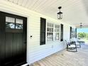 Inviting front porch with rocking chairs, updated fixtures, and black shutters adds curb appeal at 147 Dutchman Rd, Harmony, NC 28634