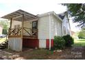 Rear view of the house featuring a wooden deck and backyard at 1541 Kings Rd, Shelby, NC 28150