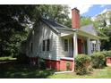 A side view of the home highlighting the windows and yard at 1541 Kings Rd, Shelby, NC 28150