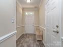 Light and bright foyer with durable floors, bench and neutral decor leading into the home at 15739 Circlegreen Dr, Charlotte, NC 28273