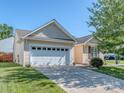 Traditional home with attached garage, tidy lawn and mature tree offering ample shade at 15739 Circlegreen Dr, Charlotte, NC 28273