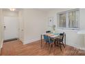 Inviting dining area features a table and chairs near a window, providing natural light at 207 N Dotger Ave # C14, Charlotte, NC 28207
