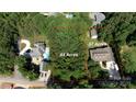 Aerial view showcasing the property's .64 acres, landscaping, and proximity to neighboring homes at 260 River Country Rd, Salisbury, NC 28146