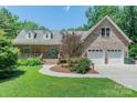 Charming brick home with a two-car garage, manicured lawn, and inviting front porch at 260 River Country Rd, Salisbury, NC 28146