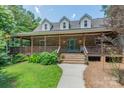 Inviting brick home with a spacious covered porch and charming curb appeal at 260 River Country Rd, Salisbury, NC 28146