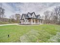 Eye-catching two-story home with a long driveway, a covered front porch, and a manicured lawn at 4023 Yesteryears Ln, Marshville, NC 28103