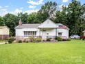 Quaint one-story home with brick accents, tidy lawn, and the American Flag waving out front at 409 E 18Th St, Kannapolis, NC 28083