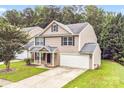 An elevated view of a two-story home with a well-manicured lawn and an attached garage at 4412 Trillium Fields Dr, Charlotte, NC 28269