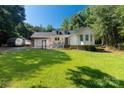 Beautiful home with a lush green lawn, inviting porch, and a serene, wooded backdrop at 4567 Hickory Grove Rd, Sharon, SC 29742