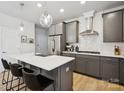 Modern kitchen with granite countertops, stainless steel appliances, and gray cabinets, and island with seating at 5008 Calvine Mill Way, Charlotte, NC 28205