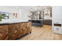 Open-concept kitchen featuring a large center island, stainless steel appliances, and stylish pendant lighting at 5008 Calvine Mill Way, Charlotte, NC 28205