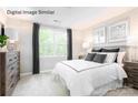Bright bedroom with large window, modern furniture, and neutral decor at 5213 Crimson Kate Ln # 2007B, Charlotte, NC 28208