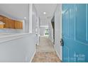Inviting entryway with tile flooring, staircase, and view to the open living area at 5724 Cougar Ln, Charlotte, NC 28269