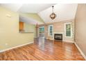 Open living room with fireplace, hardwood floors, and sliding door to a patio at 610 Mountain Pl, Albemarle, NC 28001