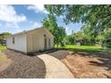 Detached garage featuring a stylish entrance surrounded by landscaped features and a cozy pathway at 6208 Karenstone Dr, Charlotte, NC 28215