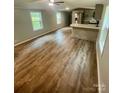 Open concept living room and kitchen area feature laminate floors and recessed lighting at 6517 Helens Way, Denver, NC 28037