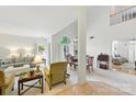 Bright, open-concept living area featuring large windows, neutral tones, and access to the dining room at 7014 Walton Heath Ln, Charlotte, NC 28277