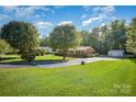 Brick home on expansive lot, showcasing lush greenery and long driveway at 753 Briarfield Rd, Rock Hill, SC 29730