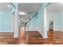 Open-concept living room showcasing elegant pillars and gleaming hardwood floors at 8000 Pelorus Ln, Charlotte, NC 28269