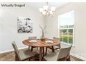 Bright dining area features natural light, seating for four, and modern decor at 8724 Tweedsmuir Glen Ln, Charlotte, NC 28215