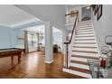 Welcoming foyer with beautiful hardwood floors and staircase to the second level at 10104 Treetop Ln, Cornelius, NC 28031