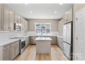Modern kitchen with stainless steel appliances, a central island, and bright lighting at 1033 12Th Avenue Nw Dr, Hickory, NC 28601