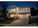 Charming two-story home with stone accents, blue shutters, and a well-manicured front lawn at 116 Kingsway Dr, Mooresville, NC 28115