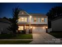 Charming two-story home with stone accents, blue shutters, and a well-manicured front lawn at 116 Kingsway Dr, Mooresville, NC 28115