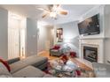 Comfortable living room with fireplace, ceiling fan, and neutral paint scheme at 14755 Lions Paw St, Charlotte, NC 28273