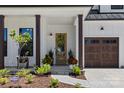 Inviting front entry with craftsman style front door, stylish planters and walkway, and a two car garage at 18027 Wilbanks Dr, Charlotte, NC 28278
