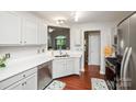 Bright kitchen features white cabinets, stainless steel appliances, and a view to the living area, perfect for entertaining at 181 Brook Glen Dr # 56, Mooresville, NC 28115