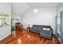 Inviting living room with hardwood floors, vaulted ceiling, and ample natural light streaming through the large window at 181 Brook Glen Dr # 56, Mooresville, NC 28115