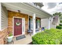 Inviting front porch with stone accents, seating, and a decorative wreath creating a warm and welcoming entrance at 1930 Caprington Dr, Fort Mill, SC 29707