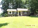 Traditional brick home featuring a well-kept lawn and covered front entry at 2116 Upson Dr, Lancaster, SC 29720
