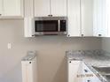 Modern kitchen featuring granite countertops and a stainless steel microwave at 2116 Upson Dr, Lancaster, SC 29720