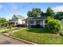 Quaint home with a cozy front porch, stone walkway, and well-maintained lawn, in a quiet neighborhood at 215 Cedar St, Belmont, NC 28012