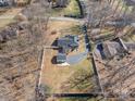 Expansive aerial view showing a well-maintained yard, driveway, and the home's roof with solar panels at 220 Augusta Dr, Statesville, NC 28625